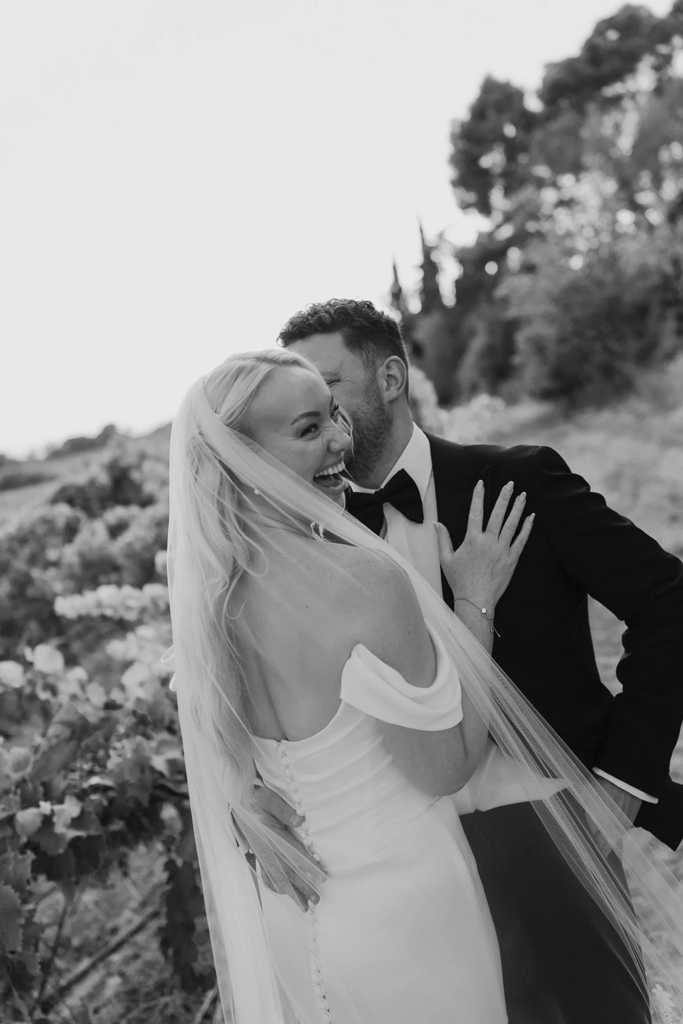 Black-and-white portrait of Mark and Sarah laughing together
